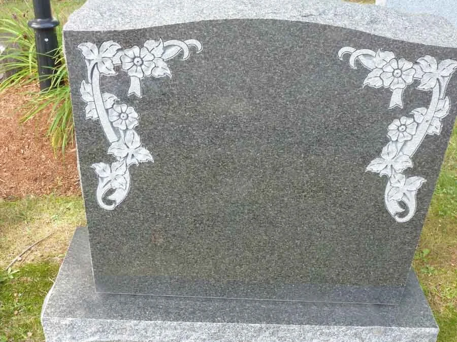 Close-up of cemetery lettering carved into granite